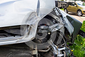 silver car nose smashed in an accident at day time