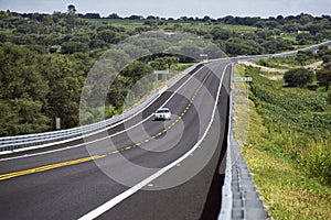 Silver car running on the road