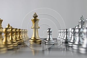 Silver chess pawn is facing golden chess king on white background. Business strategy, market share, business competition,