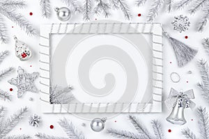 Silver Christmas background with photo frame, decorations and xmas tree branches