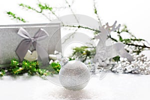 Silver Christmas balloon with festive decorations on a light background