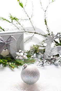 Silver Christmas balloon with festive decorations on a light background