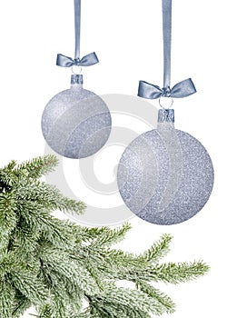 Silver Christmas balls with bow on ribbon and new year green tree isolated on white background