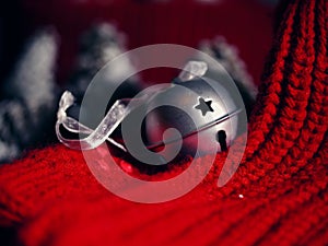 Silver Christmas bauble bell with red wool background