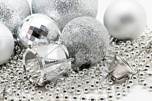 Silver Christmas decoration, balls, beads, bell close up isolate