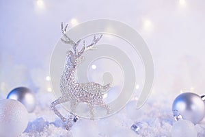 Silver christmas decoration deer and christmas balls on a pink winter background. Christmas holiday mood. Magic and fairy tale