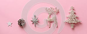 Silver Christmas decoration - deer, fir-tree, stars, cone on pink background with copy space. Festive card for winter event, party