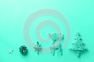 Silver Christmas decoration in mint color. Deer, fir-tree, stars, cone on monochrome background. Trendy green and turquoise color