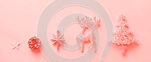 Silver Christmas decoration in trendy coral color. Deer, fir-tree, stars, cone on monochrome background with copy space. Festive