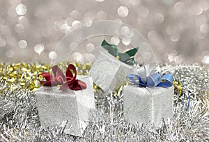 Silver Christmas gift box decoration with silver glister blurred background