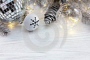 Silver christmas tree branch with decorations and retro lamps on