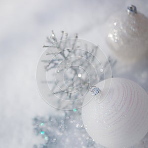 Silver Christmas tree decorations on snow