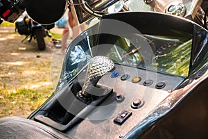 Silver cobra-shaped gear lever on a tricycle