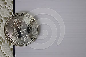 Silver coin bitcoin on white background close-up