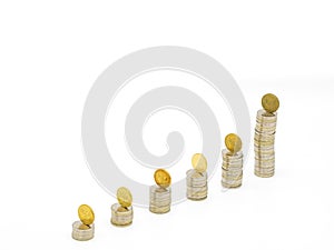 Silver coin stacks of different high with top with gold coin standing on edge. Selected focus
