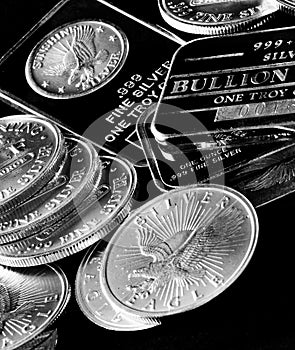 Silver Coins and Bars Representing Wealth