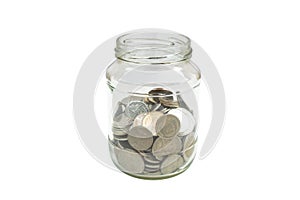 Silver coins fill half of glass jar isolated on white background.