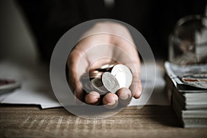 Silver coins in hands