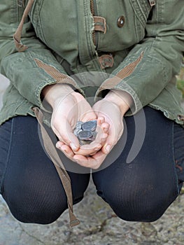 Silver coins in the hands of the poor bum. homeless person asks for money for food