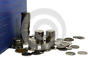 Silver coins stack with a book on white background