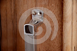 The silver color door handle on the with brown door