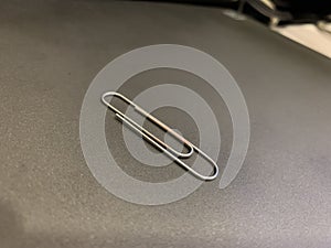 Silver color Paper clip on black background