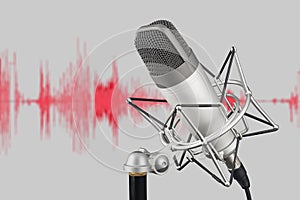 Silver colored condenser microphone on waveform background