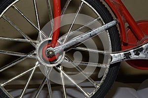 Silver colour cycle wheel, black tyre, selective focus, blurred background.