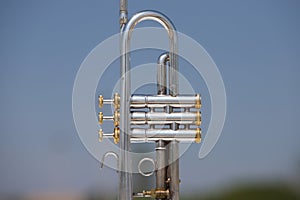 Silver coloured trumpet in the open air. october 1st international day of music