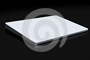 Silver computer trackpad or wireless touch pad isolated on black background photo