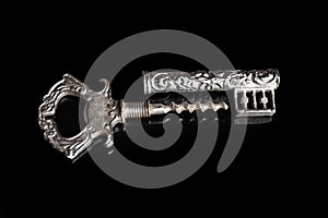 Silver corkscrew on a black background