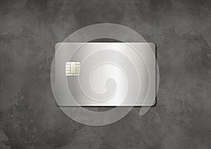 Silver credit card on a concrete background