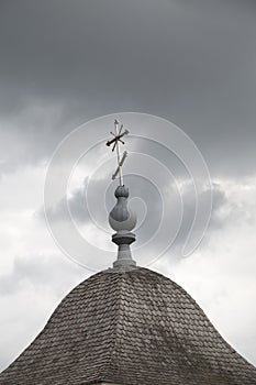 Silver cross on dome of wooden chapel