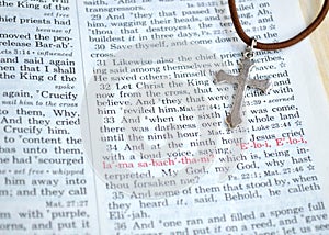 Silver cross and Good Friday Bible scripture