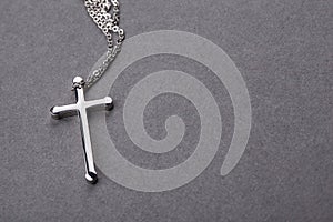 Silver cross on a gray background