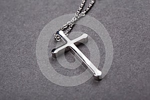 Silver cross on a gray background