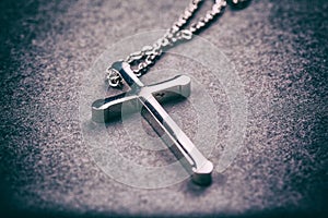 Silver cross on a gray background