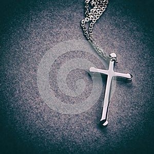 Silver cross on a gray background