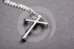 Silver cross on a gray background