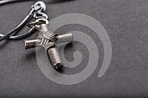 Silver cross on a gray background