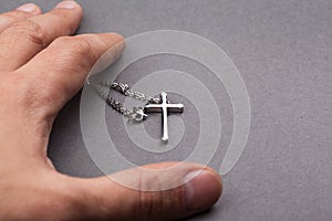 Silver cross in a hand