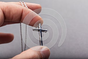 Silver cross in a hand