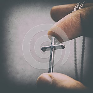 Silver cross in a hand