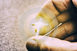 Silver cross in a hand