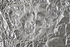 Silver crumpled foil shiny metal texture background wrapping paper for wallpaper decoration element