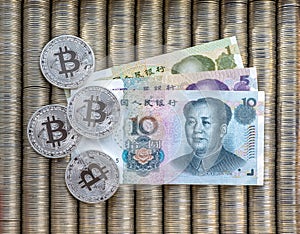 Silver Crypto coins bitcoin BTC, paper Chinese yuan. Metal coins are laid out in a smooth background to each other, close-up view