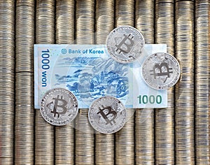 Silver crypto coins bitcoin BTC, paper Korean won. Metal coins are laid out in a smooth background to each other, close-up view fr