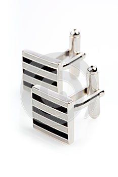 Silver cuff links on white background