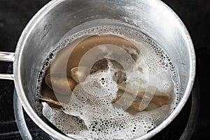Silver cutlery in boiling solution of baking soda