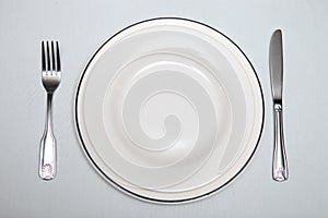 Silver cutlery, plate on the table